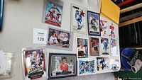 Top-down view of assortment of oversized hockey cards displayed on a table. Cards include players from various teams and series.
