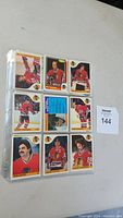 Ninety-six Chicago Blackhawks hockey cards arranged in clear Ultra Pro sheets. Cards show front views of players in team jerseys, predominantly red and black apparel.