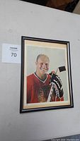 Framed signed portrait photo of Bobby Hull in red Chicago Blackhawks jersey holding a stick