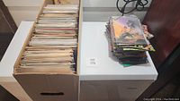 Long box filled with a large number of comic books, viewed from above showing packed contents