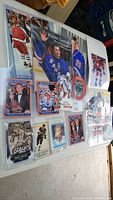 Overview image of the lot showing multiple Wayne Gretzky trading cards, posters, and puck arranged on a surface.