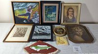 Various framed paintings, prints and decorative art pieces on white surface