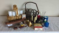 Wide view showing assorted candles, baskets, incense sticks, cones, candle holders, dried flowers, and decorative items