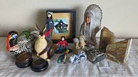 Collection of various decorative items, figurines, rock specimens, indigenous sculpture and framed art