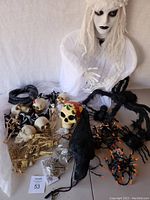 Photo of hanging banshee, skeletons, spiders, crow, snake, and painted skull as part of Halloween decor lot.