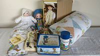 Lot display showing all dolls, comforter, sheet, book, lunch box, and thermos.