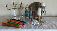 Full lot showing candles, candelabras, Madonna statue, glass holders, and brass tray