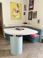 Overall view of corner booth and Formica table set against wall with art
