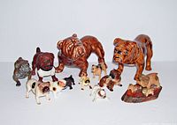 Full view of the 12 bulldog figurines arranged in a row showing size and color variations.