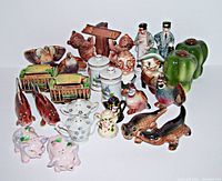 Lot of various vintage salt and pepper shakers including animal shapes, souvenir trolley cars, and flowered coffee pot shakers.
