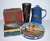 Overview of vintage plaid lunch box, hand-painted bird vase, blue enamel coffee pot, ship cookie tin, Edgeworth tins, and Niagara Falls candy tin arranged on white background