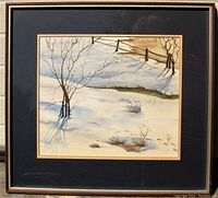 Frontal photo of the framed watercolour painting showing the entire artwork with snow-covered trees, fence, and shadows, under daylight conditions.