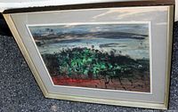 Framed abstract oil painting titled "Ibiza Primavera" with green and dark color landscape, red base, and blue-gray sky, showing overall condition and frame wear.