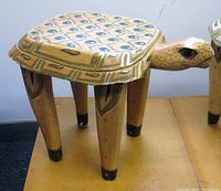 Front angle view showing the camel head detail and the painted pattern on the table top