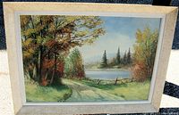 Full view of the framed oil painting showing a detailed autumn landscape with a lake and mountains.