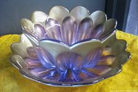 Two-piece purple art glass set with iridescent light-changing finish, showing bowl inside underplate