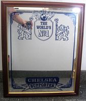 Framed mirror showing the front with Chelsea football supporter graphics including lions, 'THE WORLD'S NO1' shield, and 'CHELSEA SUPPORTER' banner.