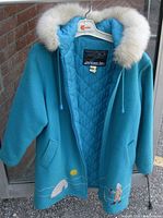 Front view of aqua wool parka on hanger
