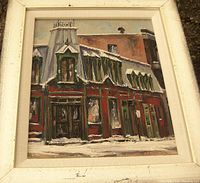 Frontal view of framed painting leaning outdoors on gravel
