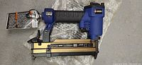 Full side view of Campbell Hausfeld RP0812 finish nailer with visible original tag attached.