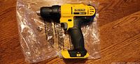 Side view of DeWalt DCD771 20V Max Cordless Drill showing brand and model information