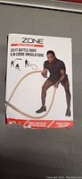 Front of product box with GoZone branding, showing a man using the 20ft battle rope in exercise.