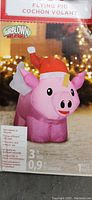 Photo of the box front showing the inflatable flying pig wearing a Santa hat with LED lights technology.