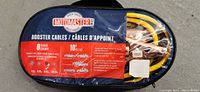 Front of carry pouch for Motomaster booster cables showing brand, 8 gauge, 10ft length, and safety info.