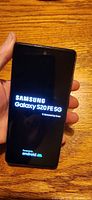 Phone powered on showing Samsung Galaxy S20 FE 5G boot screen.