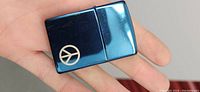 Top-front view of the metallic blue Zippo lighter showing the peace sign emblem on the front.