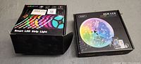 Two boxed smart LED strip lights; one box open, other sealed.