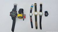 Overview of all six wristwatches laid out on white background