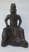 Front view of entire statue showing seated figure and base