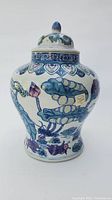 Front side view of the Chinese ginger pot showing the floral lotus and leaf design with a sticker on the body.