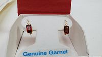 Front view of the earrings in box with Genuine Garnet label visible.