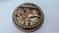 Top and side view of handmade Greek ceramic trinket box depicting Achilles on the lid, showing detailed painted artwork and decorative pattern bands.