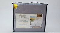 Front view of packaged queen size gray sheet set labeled Boutique Hotel Platinum Series.