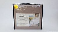 Front view of the Boutique Hotel Platinum Series queen size brown sheet set in sealed packaging showing branding, features, and thread count.