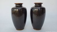 Pair of vases side by side on white background