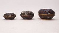 Front view of all three miniature round cloisonné trinket boxes showing different sizes and intricate floral patterns with birds.