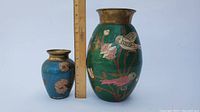 Photo of both enamel copper vases side by side with a ruler showing smaller vase approx 6 inches tall