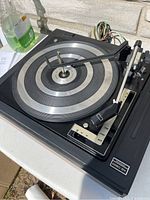 Overview of BSR Pro Series turntable platter and tonearm on a black base with control markings visible.