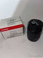Canon EF 28-80mm f/3.5-5.6 lens with original box shown in the background.
