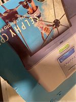 Box of Canon Selphy CP510 compact photo printer, showing part of the packaging design with photo and branding