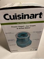 Box front showing Cuisinart branding and product features such as double insulated freezer bowl and new mixing paddle.
