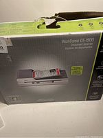 Photo of the Epson WorkForce GT-1500 scanner in original box showing product image and some minor box damage