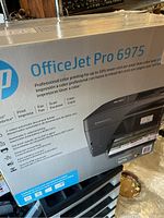 Box of HP OfficeJet Pro 6975 showing full product name and branding.