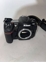 Front angle of Nikon D300 camera body without lens showing the sensor and Nikon branding.