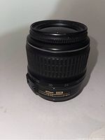 Front view of Nikon 18-55mm lens showing focal length markings and Nikon DX branding