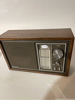 Front view of the Panasonic table radio showing speaker, tuning dial, and control knobs.